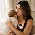 Load image into Gallery viewer, Mum holding her baby while wearing the BabyNera FlowEase wearable breast pump.