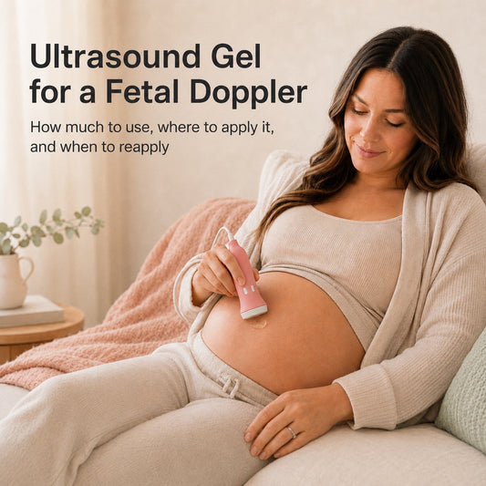Pregnant woman applying a fetal doppler probe with ultrasound gel to her belly while relaxing at home