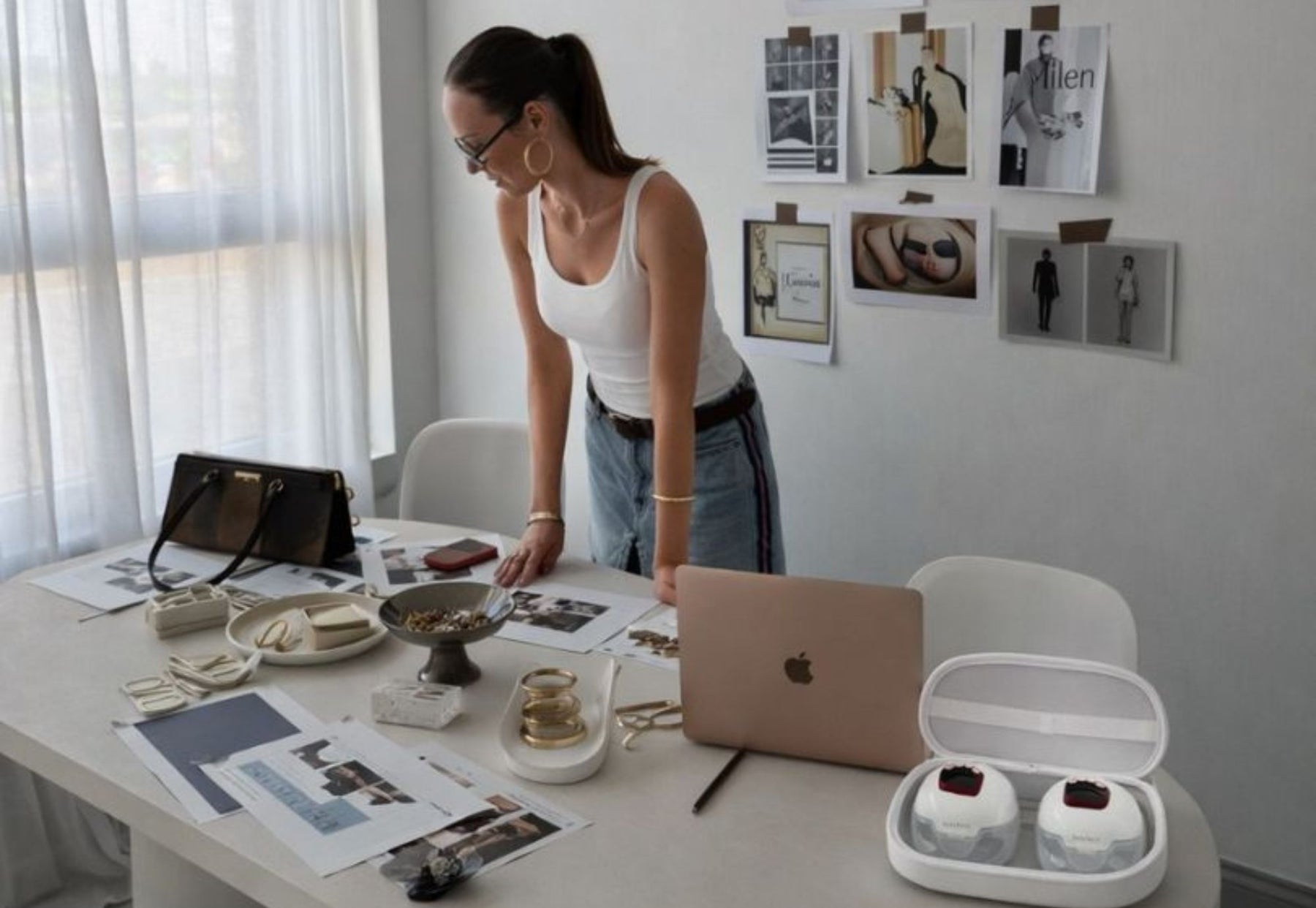 woman using wearable breast pump at work desk
