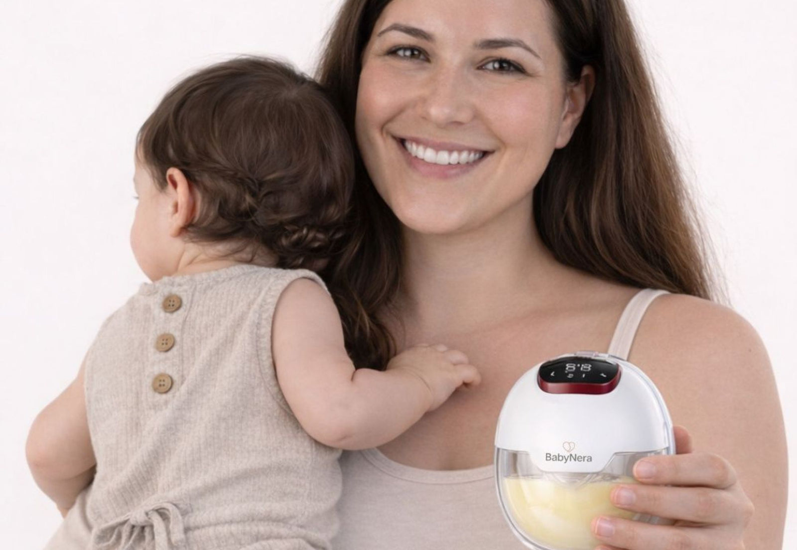 mum holding baby with clean wearable breast pump ready for use