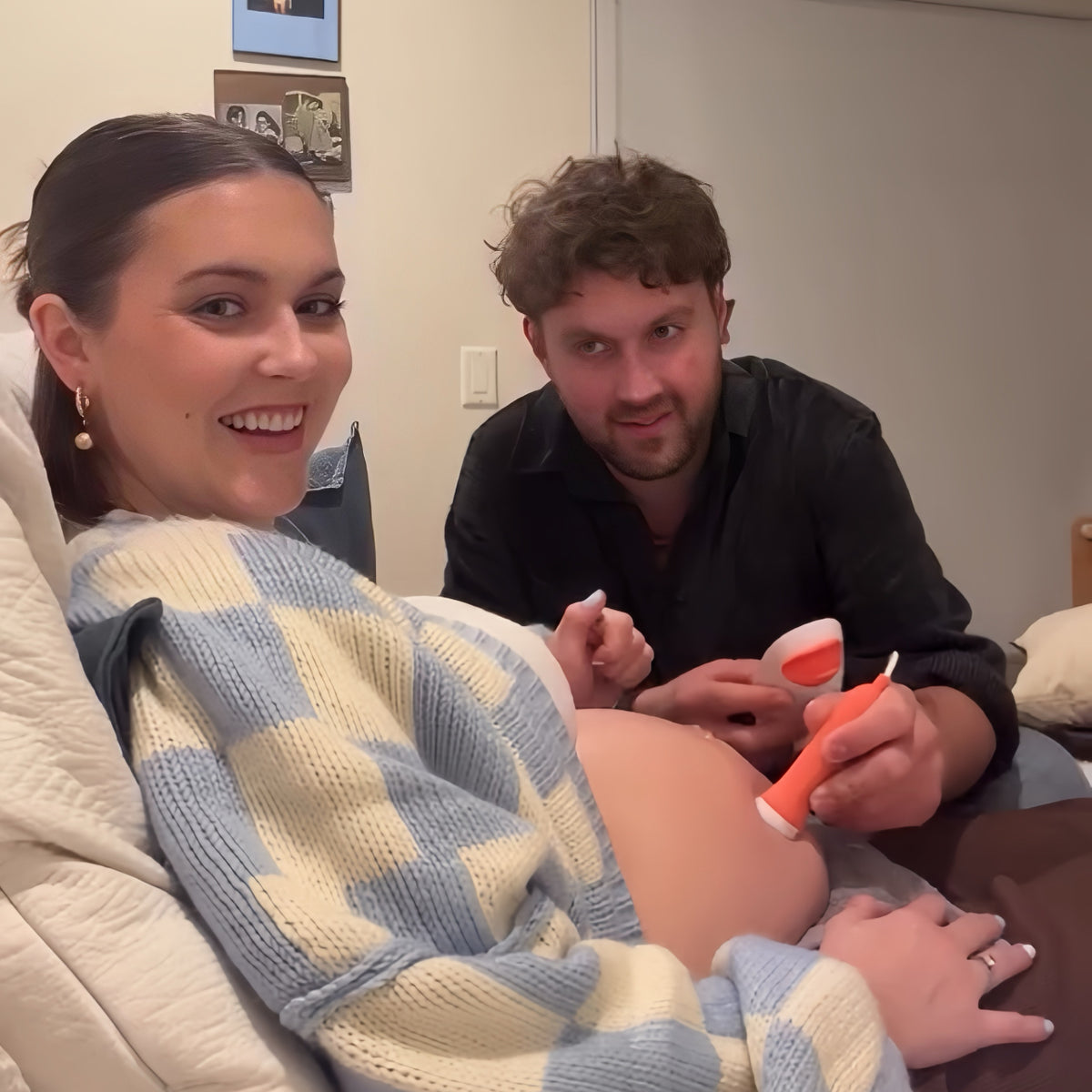 Parents listening to baby’s heartbeat at home