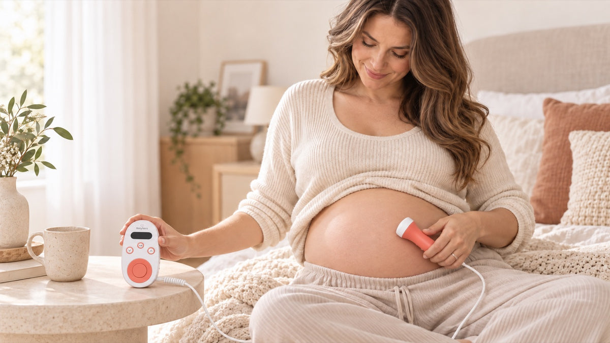 Pregnant mom in second trimester using a BabyNera HeartEcho fetal doppler at home to listen to baby's heartbeat