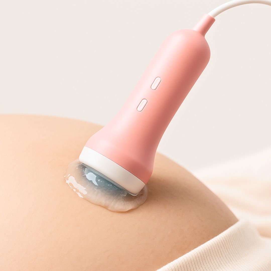 handheld fetal doppler probe with ultrasound gel used on pregnant belly to monitor baby heartbeat at home