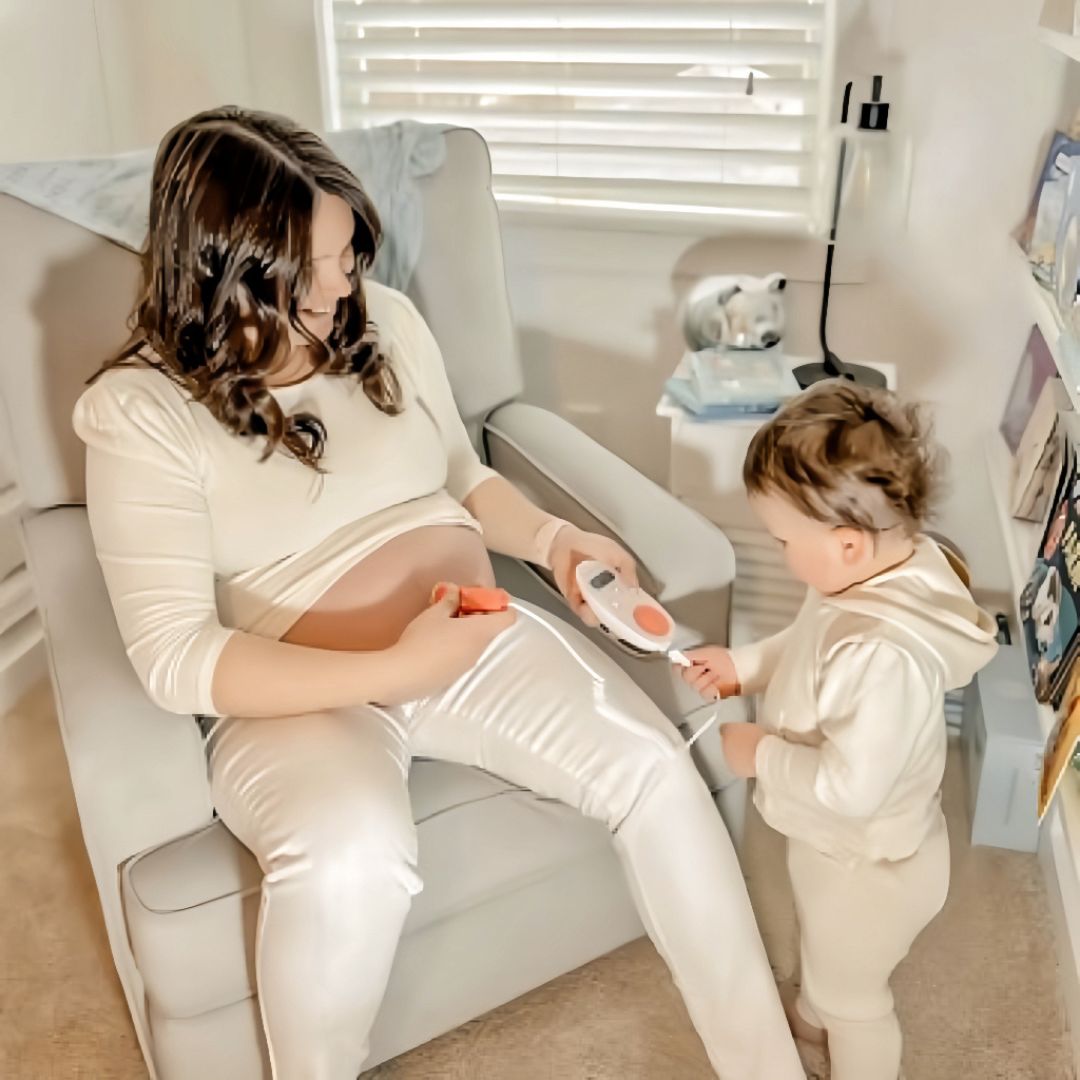 Parents listening to baby’s heartbeat at home
